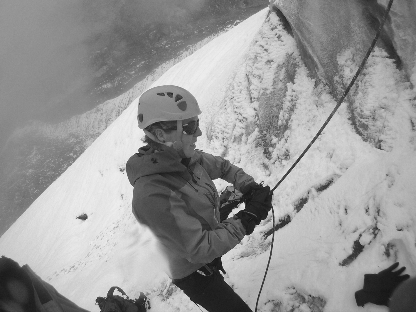 Dr Lucy Obolensky climbing on a snowy mountain with a rope