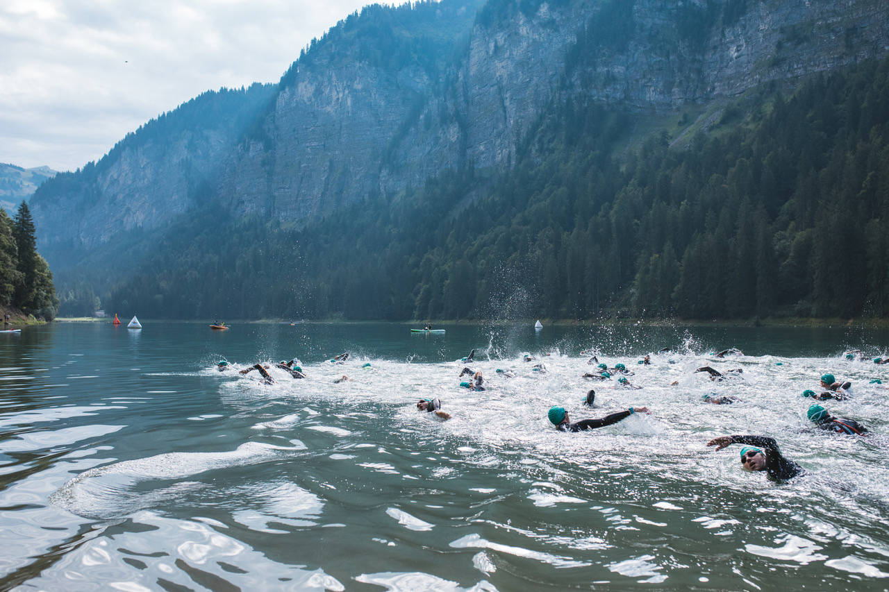 elite athlete swimming in a mountain lake during a triathlon